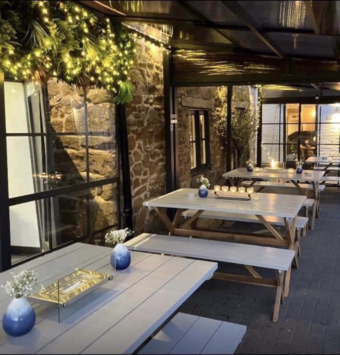 Fairy-lit terrace tables outside the Garden Room