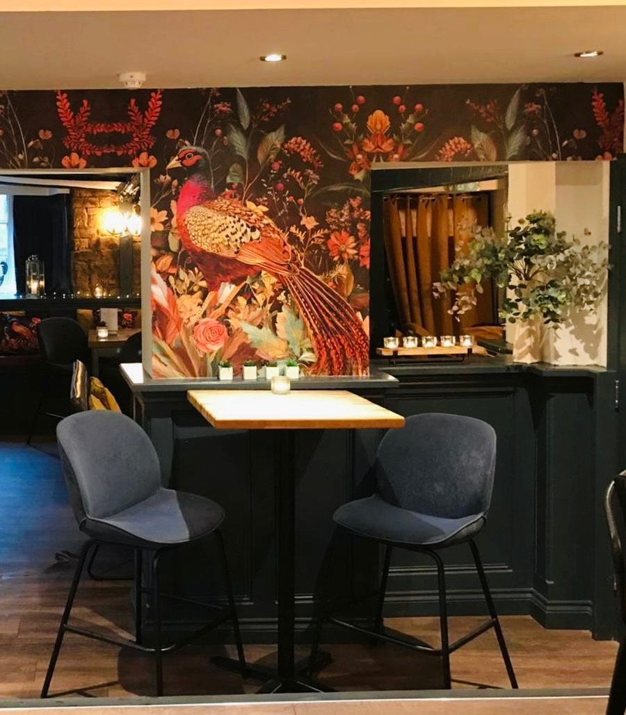 Bar seating beneath the pheasant wallpaper